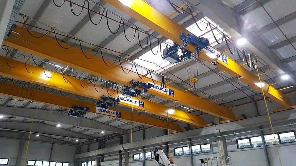 Overhead crane on factory ceiling tracks for material handling